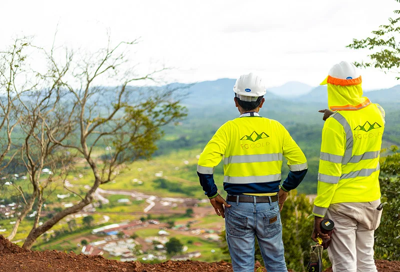 Two FG Gold staff members looking over a mountain